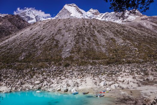 Turquoise Paron laguna in Cordillera Blanca at sunny day, snowcapped Andes, Ancash, Peru