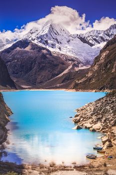 Turquoise Paron laguna in Cordillera Blanca at sunny day, snowcapped Andes, Ancash, Peru