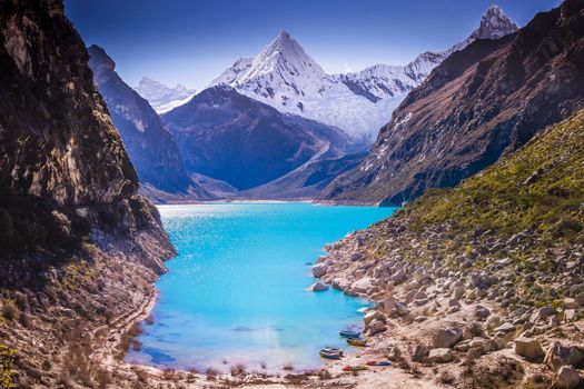 Turquoise Paron laguna in Cordillera Blanca at sunny day, snowcapped Andes, Ancash, Peru
