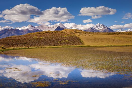Turquoise laguna Wilcacocha with mirrored reflection in Cordillera Blanca, snowcapped Andes, Ancash, Peru