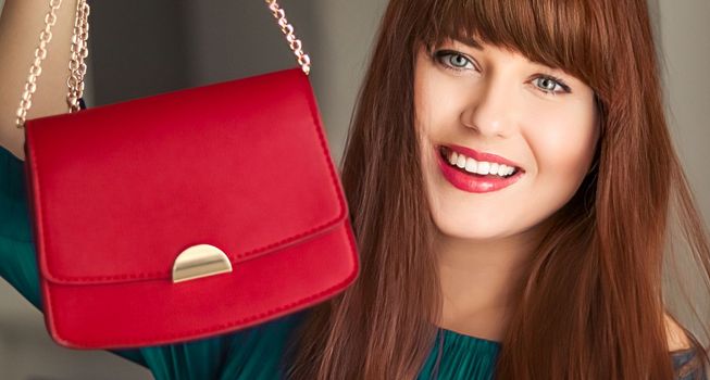 Fashion and accessories, happy beautiful woman holding small red handbag with golden details as stylish accessory and luxury shopping concept