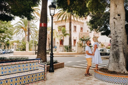 A couple in love stands in the city of Santa Cruz on the island of Tenerife, Canary Islands, Spain.