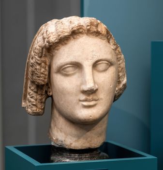 Berlin, Germany - 18 September 2019: Sculpture bust A qween with the curles of Isis in Berlin museum. Statue head at art exhibition in Germany