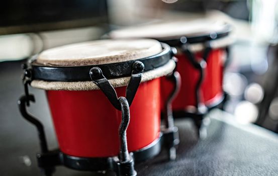 Red drums in recording studio for hard beat perfomance. Professional musical instrument for rock and pop concerts