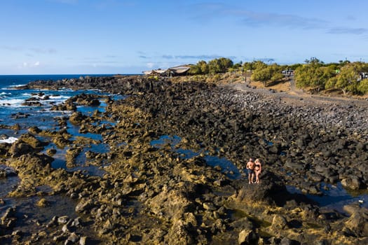 The couple stands on Rough rock formations near the ocean on the island of Tenerife.The Canary Islands.Tenerife.Spain.