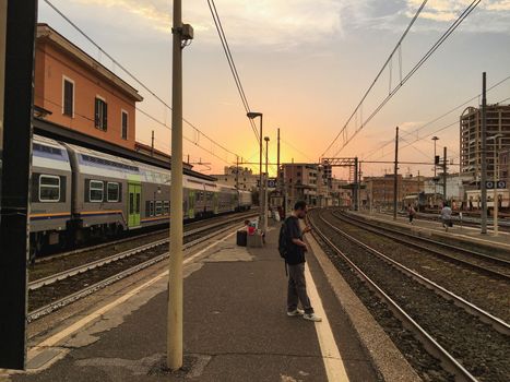 Waiting for a train at the train station in barcelona spain with overhead power lines. High quality photo