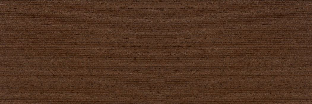 Texture of wenge wood. Dark brown wood for furniture or flooring. Close-up of a Wenge wooden plank, top view