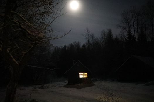 Old house in the forest at night. Old mystic building in night tree forest with moon