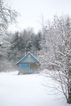 winter landscape panorama with wooden house in the forest. Snow covered hut. Christmas holiday and winter vacations concept.
