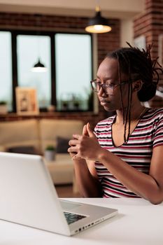 Remote employee chatting on videocall, briefing on online meeting, woman working on laptop in home office. Student attending webinar, talking on teleconference, telecommunications concept