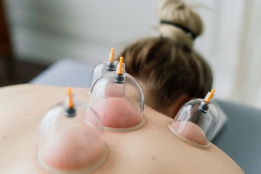 Young fat woman getting massage treatment in a day spa cabinet.