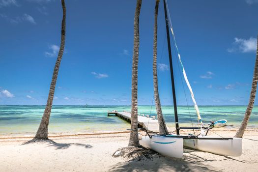 Idyllic Beach with boats and pier in Punta Cana at sunny day, Bavaro, Caribbean sea