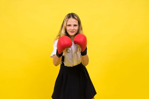 An adorable little girl boxer practicing punches in a studio