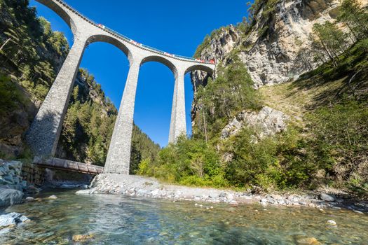Swiss train over Landwasser Viaduct bridge in the alps, Graubunden valley, Switzerland