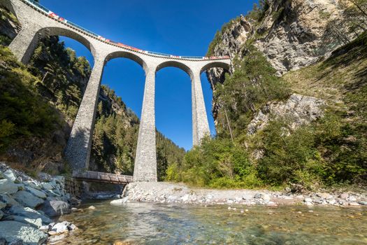 Swiss train over Landwasser Viaduct bridge in the alps, Graubunden valley, Switzerland