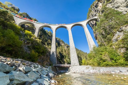 Swiss train over Landwasser Viaduct bridge in the alps, Graubunden valley, Switzerland