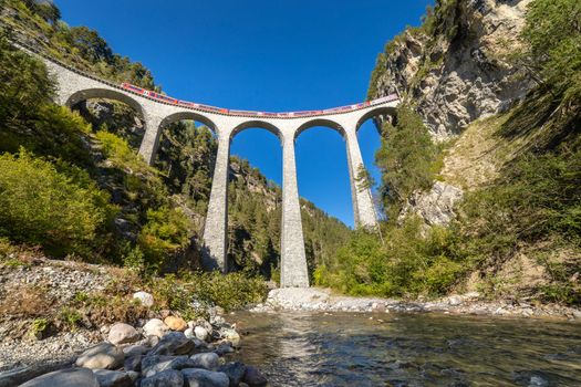 Swiss train over Landwasser Viaduct bridge in the alps, Graubunden valley, Switzerland