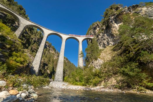 Swiss train over Landwasser Viaduct bridge in the alps, Graubunden valley, Switzerland