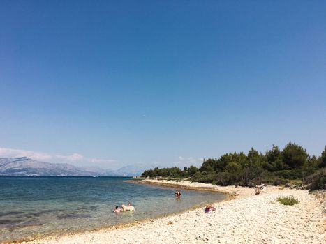 Brac Island Croatia in the middle of summer. With boats and people enjoying summer in the sandy bay. . High quality photo