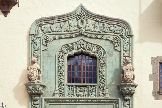 An exterior portal topped by a Tudor-style arch with two lions supporting the city's coat of arms. Columbus House aka Casa de Colon in Las Palmas, Canary Islands, Spain.