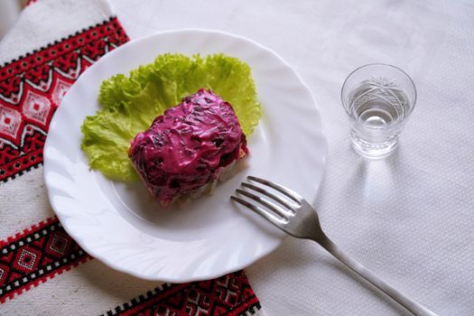 Traditional Ukrainian food on the table with embroidered tablecloth.