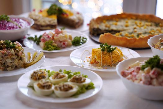 Traditional Ukrainian food on the table with embroidered tablecloth.