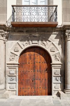 Old historical gate under balcony in Las Palmas de Gran Canaria, Spain