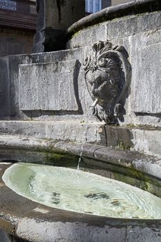 Outdoor fountain with medieval architecture and palm trees at Plaza del Espiritu Santo in Vegueta, Las Palmas de Gran Canaria, Spain