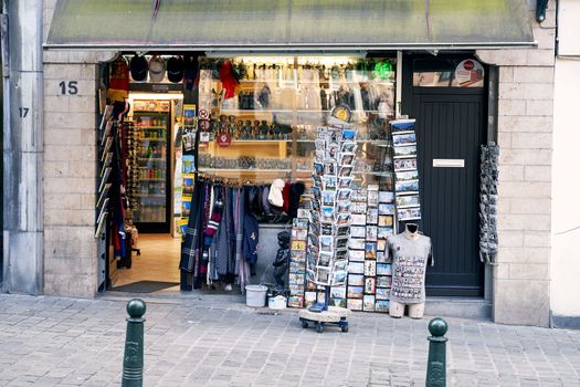 Brussels, Belgium, 4 April 2019 - Small street gift shop with many postcards, traditional souvenirs, food, and drinks.