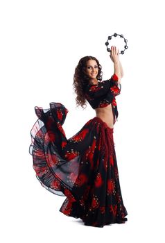 Young beauty woman dance in gypsy costume with tambourine isolated