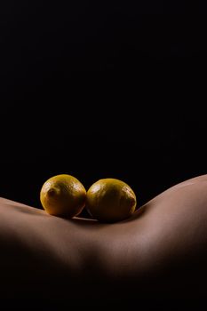 Lemon, natural vitamin c help skin whitening. Naked woman lying on back with fruit located