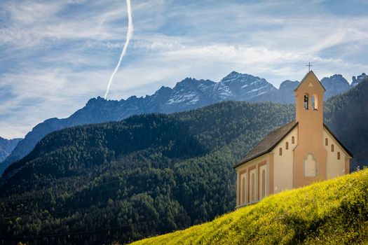 Idyllic landscape of Ardez church at sunrise, Engadine, Swiss Alps, Switzerland