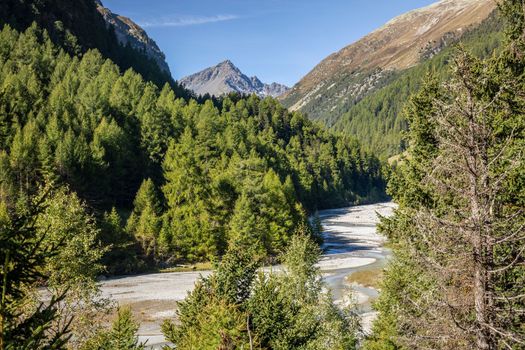 Alpine river in Engadine Valley at sunrise, Graubunden alps, Grisons, Switzerland