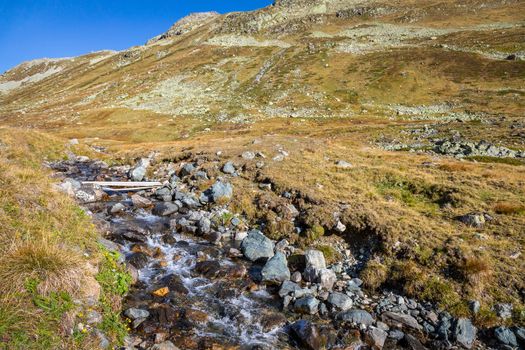 Alpine river in Fluela pass, Engadine Valley at sunrise, Graubunden alps, Grisons, Switzerland