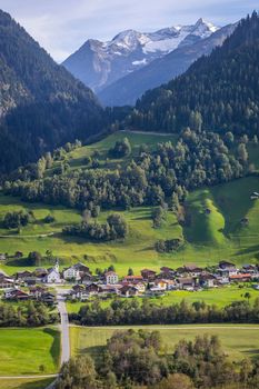 Idyllic landscape of village in Engadine valley at sunny springtime, Swiss Alps, Switzerland
