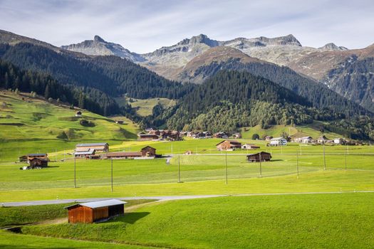 Idyllic landscape of village in Graubunden valley at sunny springtime, Swiss Alps, Switzerland