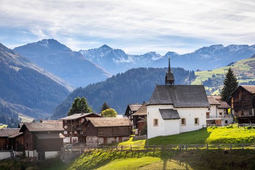 Idyllic landscape of village in Graubunden valley at sunny springtime, Swiss Alps, Switzerland