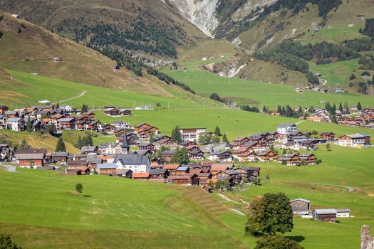 Idyllic landscape of village in Graubunden valley at sunny springtime, Swiss Alps, Switzerland