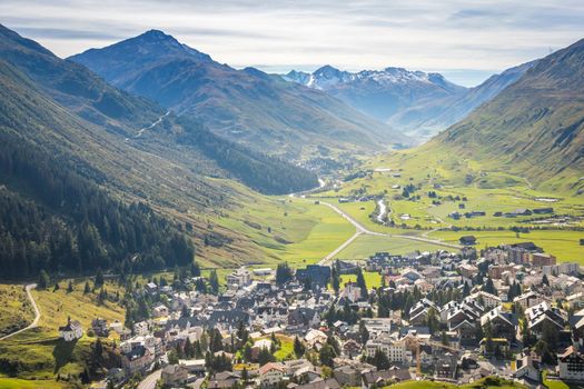 Idyllic landscape of Andermatt village in Urseren valley at sunny springtime, Swiss Alps, Switzerland