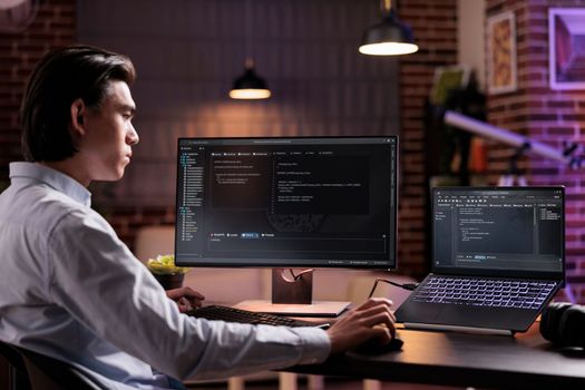 Asian developer using binary code to script security system, programming firewall encryption. Working with program data server to develop network on coding software, using advanced app interface.