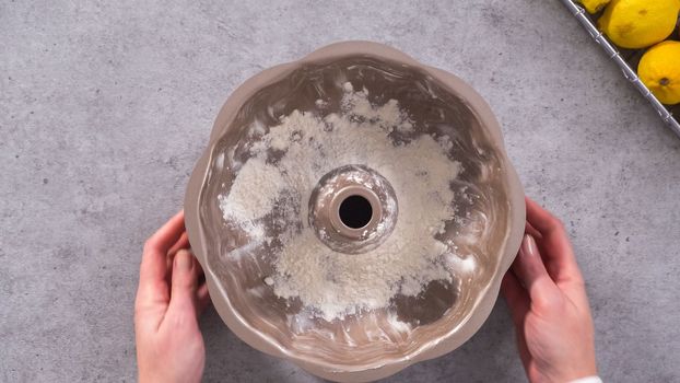 Flat lay. Step by step. Greasing bundt cake pan to bake lemon cranberry bundt cake.