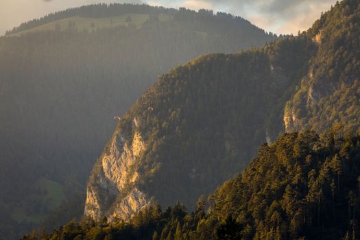 Paragliding above Lauterbrunnen valley at sunset, Snowcapped Bernese Swiss alps, Switzerland