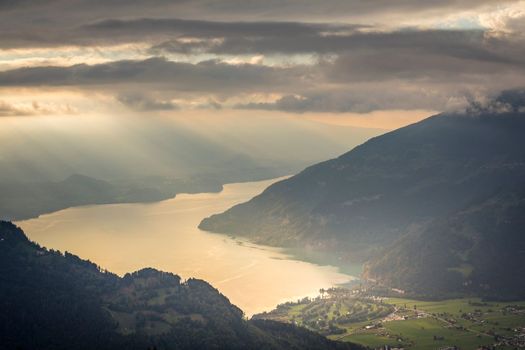 Aerial view of Swiss Alps and Lake Thun at dramatic sunset, Interlaken, Switzerland