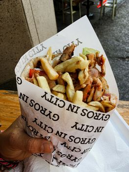 Doner kebab packed with fries and sauce in the european summer street food . High quality photo