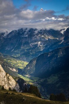 Misty Mountain above Grindelwald valley, Snowcapped Bernese Swiss alps at sunset, Switzerland