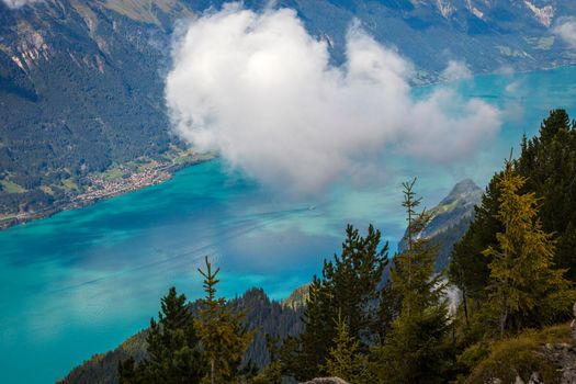 Aerial view of Swiss Alps and Lake Brienz with ferry boat at dramatic sunset, Interlaken, Switzerland