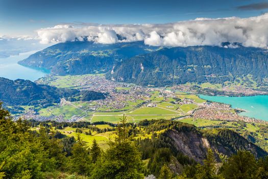 Aerial view of Swiss Alps and Lake Thun and Brienz at dramatic sunset, Interlaken, Switzerland