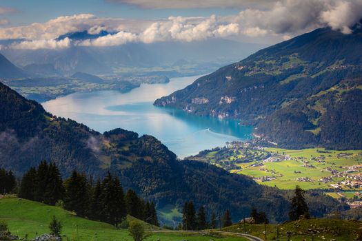 Aerial view of Swiss Alps and Lake Thun at dramatic sunset, Interlaken, Switzerland