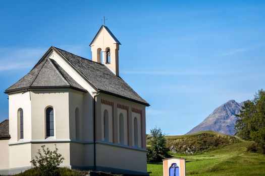 Idyllic landscape of Ardez church at sunrise, Engadine, Swiss Alps, Switzerland