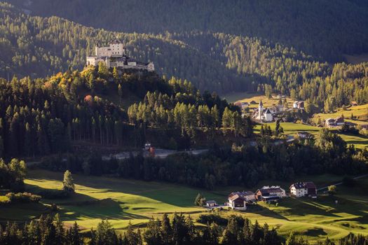 Above Idyllic landscape of Scuol Tarasp village at sunrise, Engadine, Swiss Alps, Switzerland